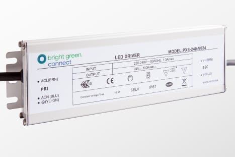 A rectangular bright green connect LED driver (Model: PXS-240-V024) with input specifications of 220-240V, 50/60Hz, and output specifications of 24V and 10A. The driver features various technical details printed on its casing.